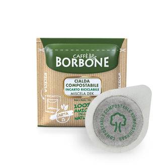 a box of borbone coffee pods next to a cup of coffee