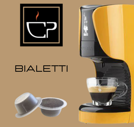 a bialetti coffee machine with a cup of coffee next to it