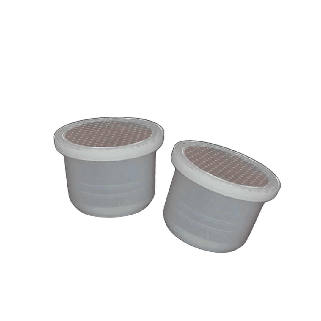 two Fior Fiore coffee capsules on a white background