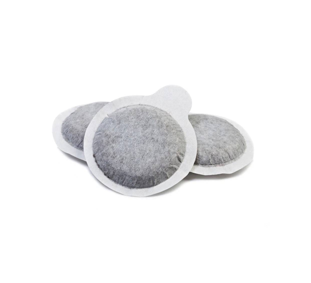 three coffee pods on a white background