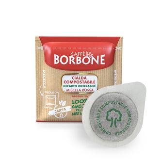 a package of borbone coffee pods next to a bag of coffee grounds